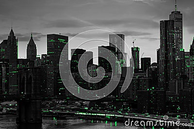 Green lights shining in black and white night time cityscape with the Brooklyn Bridge and buildings of Manhattan in New York City Stock Photo